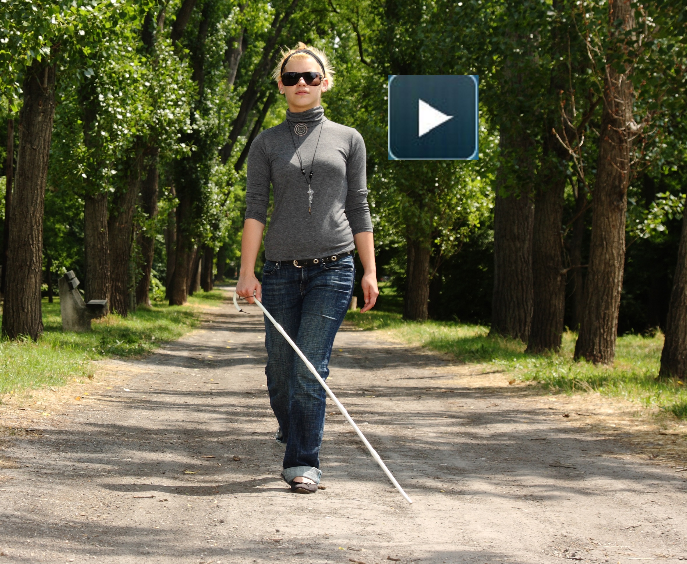 blind woman walking in a park.