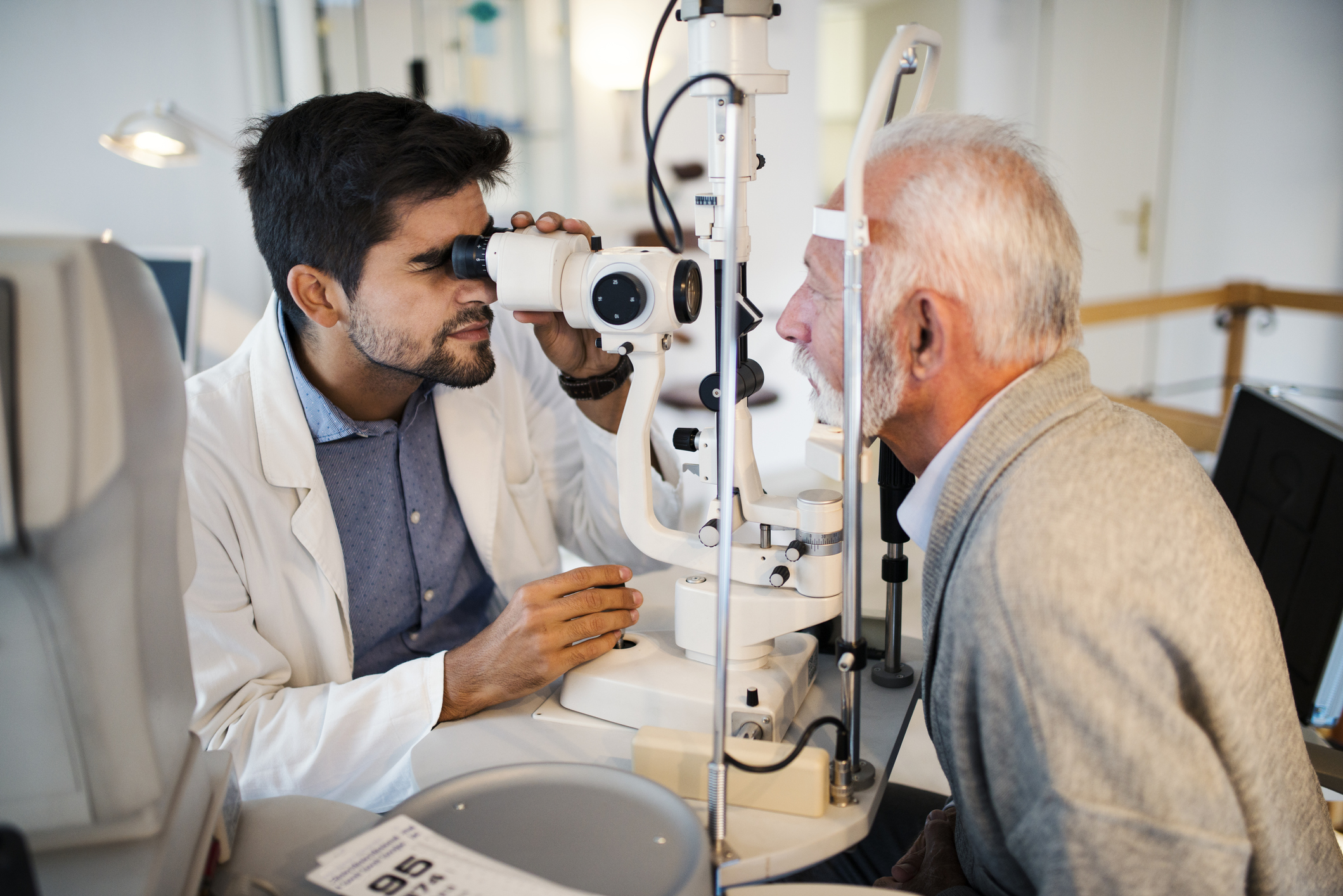 Old men having an eye exam at ophthalmologist's office. - Review of  Optometric Business