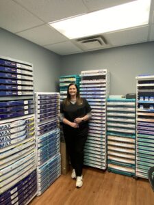 Optometrist in her office's contact lens supply room where trial contact lenses are stored. 