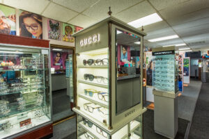 A photo of an optical shop showing Gucci frames and other stylish eyewear brands.