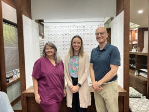 Optometrist with members of his optical team. He says the practice as worked conscientiously to successfully reduce monthly shipping costs across its five locations.